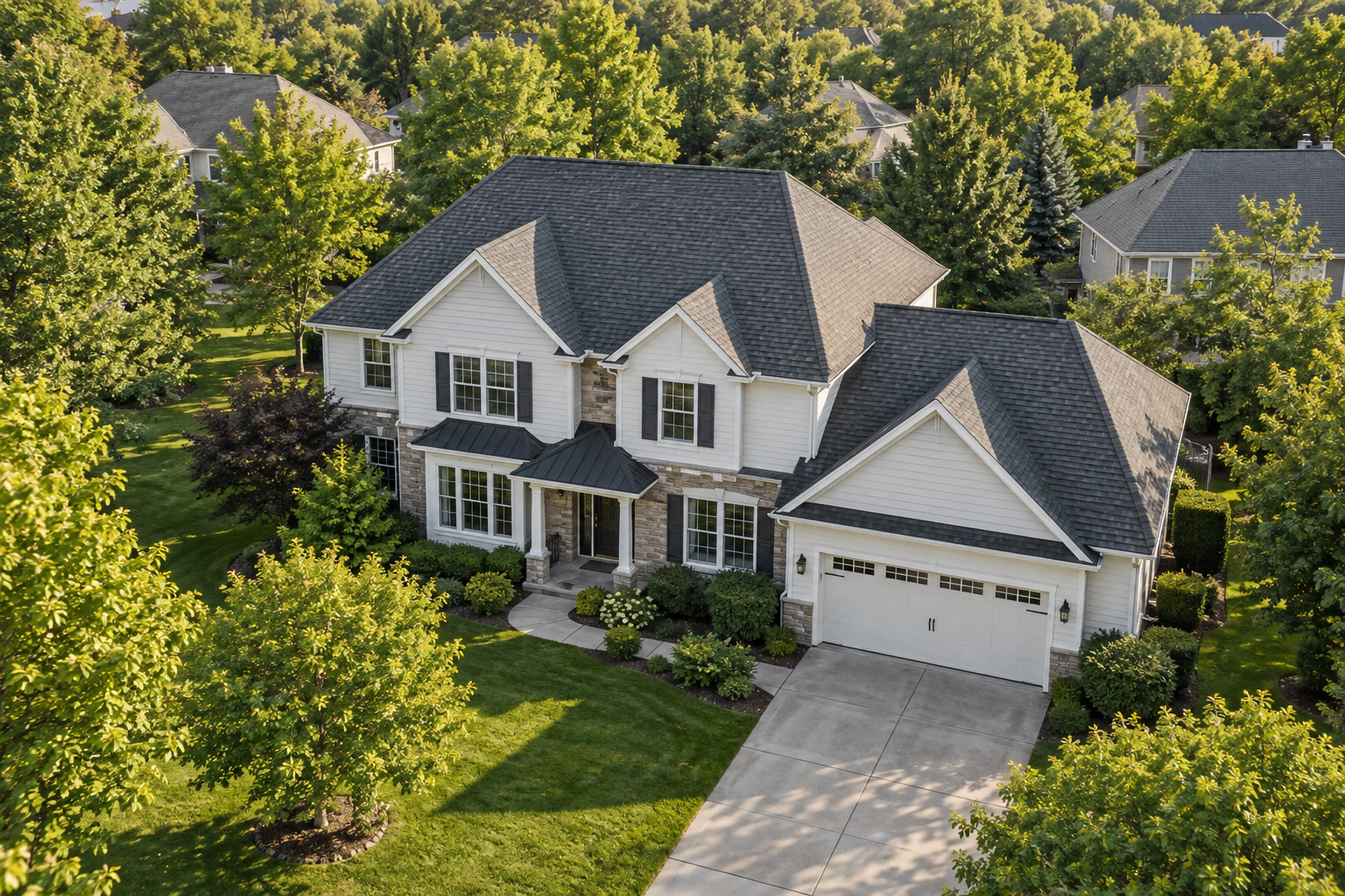 Illustrative aerial view of a white home with a dark shingle roof and mature trees